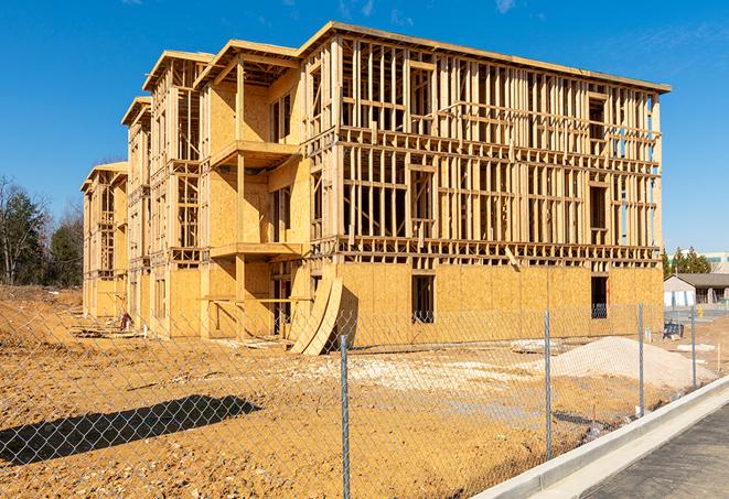 a temporary chain link fence surrounding a job site, requiring strict safety precautions in Arlington, KS